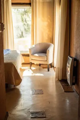 a living room with a chair and a window at Brisas de Chacras in San Javier