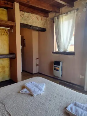 a bedroom with a bed with towels on it at Brisas de Chacras in San Javier