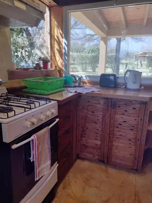 a kitchen with a stove and a sink at Brisas de Chacras in San Javier