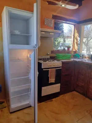 a kitchen with an open refrigerator and a stove at Brisas de Chacras in San Javier