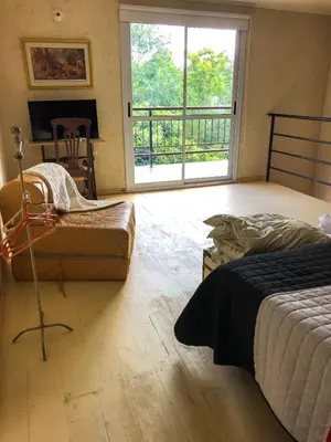 a bedroom with a bed and a view of a balcony at Departamentos El Milagro in Tanti