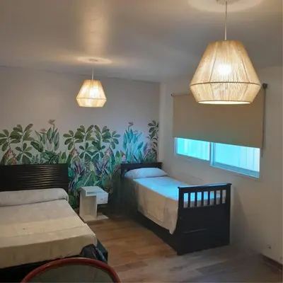 a bedroom with a bed and two lights at Departamento Bolivar in Cordoba