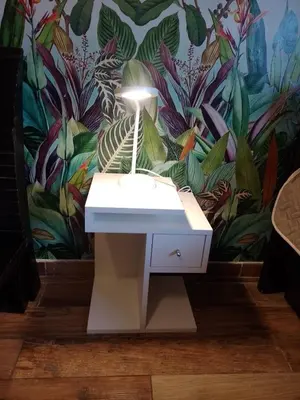 a lamp on a white table in front of a mural at Departamento Bolivar in Cordoba