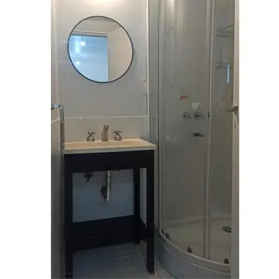 a bathroom with a sink and a shower at Departamento Bolivar in Cordoba