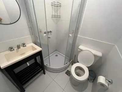 a bathroom with a shower and a toilet and a sink at Departamento Bolivar in Cordoba