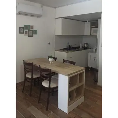 a kitchen with a table and chairs in a room at Departamento Bolivar in Cordoba