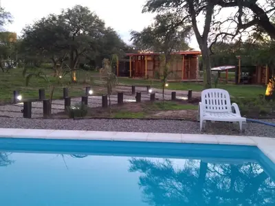 a white bench sitting next to a swimming pool at La Comarca in San Javier