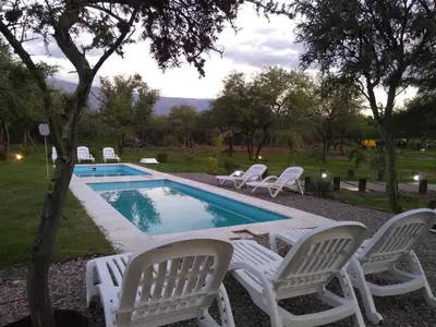 a group of white chairs around a swimming pool at La Comarca in San Javier