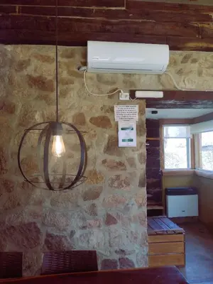 a light hanging from a wall with a stone wall at La Comarca in San Javier