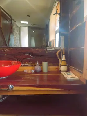 a wooden counter with a red bowl and vases on it at La Comarca Loft in San Javier