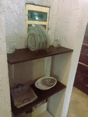 a bathroom with a sink and a plate on a shelf at La Comarca Loft in San Javier