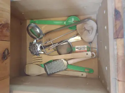 a box filled with cooking utensils and spatulas at La Comarca Loft in San Javier