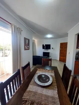 a dining room table with a plate on top of it at Depto Centro de Carlos Paz in Villa Carlos Paz