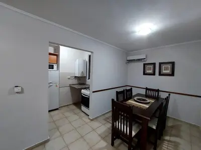 a kitchen and dining room with a table and chairs at Depto Centro de Carlos Paz in Villa Carlos Paz