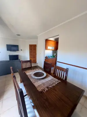 a dining room with a wooden table and chairs at Depto Centro de Carlos Paz in Villa Carlos Paz