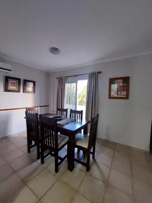 a dining room with a table and chairs and a window at Depto Centro de Carlos Paz in Villa Carlos Paz