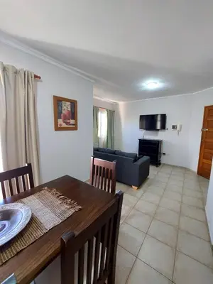 a living room with a table and a couch at Depto Centro de Carlos Paz in Villa Carlos Paz
