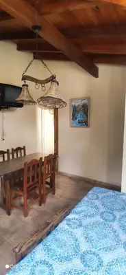a dining room with a wooden table and chairs at SARA COMPLEJO in Mina Clavero