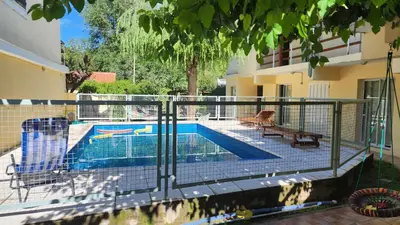 a fence around a swimming pool in a house at SARA COMPLEJO in Mina Clavero