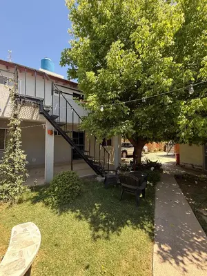 a yard with a staircase in front of a house at Romedeptos I in Merlo