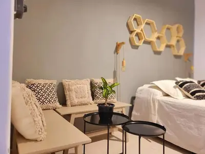 a living room with a couch and a table at Casa Roque Funes, ubicado en Cerro de las Rosas Córdoba, Ofrece, Asador, Pileta, Cercanias, Estadio Kempes, aeropuerto Ambrosio Taravella, Orfeo Superdomo, Sanatorio Allende, Casa con 2 departamentos individuales y áreas comunes in Cordoba