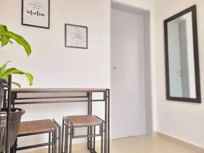 a table and two stools in a room with a mirror at Casa Roque Funes, ubicado en Cerro de las Rosas Córdoba, Ofrece, Asador, Pileta, Cercanias, Estadio Kempes, aeropuerto Ambrosio Taravella, Orfeo Superdomo, Sanatorio Allende, Casa con 2 departamentos individuales y áreas comunes in Cordoba