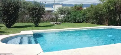 a large swimming pool in a yard with a yard at Casa LA SULISA in Merlo