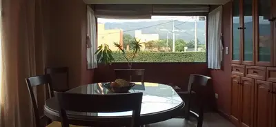 a dining room with a table and chairs and a window at Casa LA SULISA in Merlo