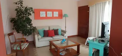 a living room with a couch and a table at Casa LA SULISA in Merlo