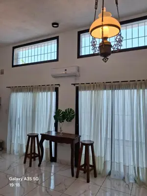 a dining room with a table and two stools at Monserrat in Cordoba