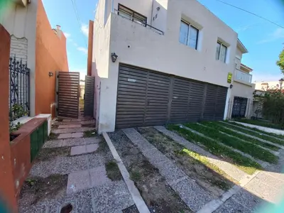a house with a garage door in front of it at Monserrat in Cordoba