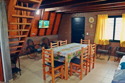 a dining room with a table and chairs at Complejo de Cabañas Valentino in Embalse