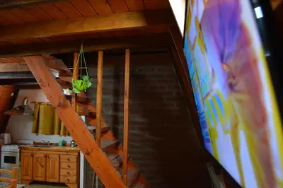 a wooden staircase in a room with a kitchen at Complejo de Cabañas Valentino in Embalse