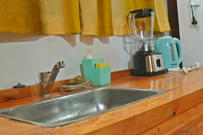 a kitchen counter with a sink and a blender at Complejo de Cabañas Valentino in Embalse