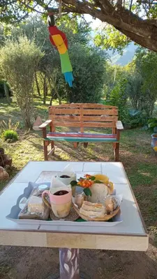a tray of food on a table next to a bench at Cabaña Providencia in Cortaderas