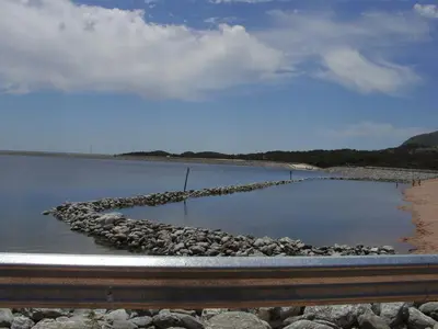 a body of water with rocks on the shore at Cabaña Providencia in Cortaderas