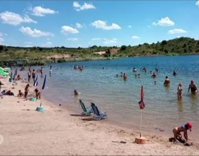 a group of people in the water at a beach at Cabaña Providencia in Cortaderas