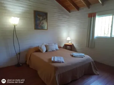 a bedroom with a bed with two towels on it at Cabaña Providencia in Cortaderas