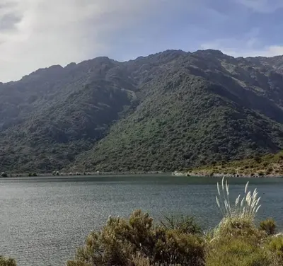a large body of water with mountains in the background at Cabaña Providencia in Cortaderas