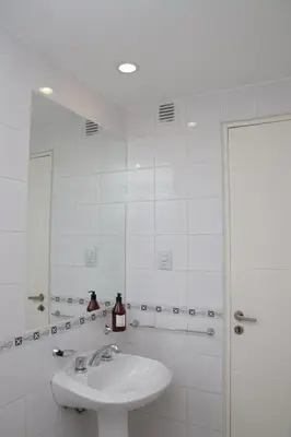 a white bathroom with a sink and a shower at Malanca - Nueva Córdoba in Cordoba