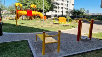 a playground with a yellow slide in a park at Moderno dpto 1 dorm cerca de hospitales y terminal 4 personas in Cordoba