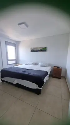 a bedroom with a large bed in a white room at Moderno dpto 1 dorm cerca de hospitales y terminal 4 personas in Cordoba