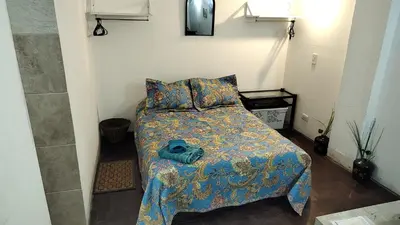 a bedroom with a bed with a blue stuffed animal on it at Monoambiente Amoblado in Cordoba