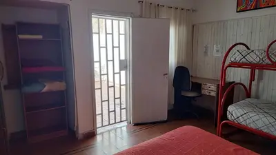 a room with a bedroom with a bed and a window at Habitación Privada en casa compartida, para mujeres, parejas, grupo mixto in Cordoba