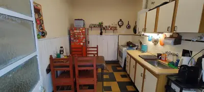 a kitchen with a sink and a table and chairs at Habitación Privada en casa compartida, para mujeres, parejas, grupo mixto in Cordoba