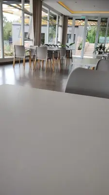 a dining room with chairs and tables and windows at Veneto Village, Complejo Vacacional in Villa Parque Siquiman