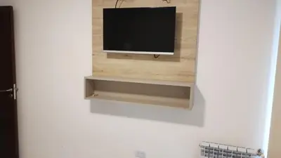 a flat screen tv on a wall in a room at Veneto Village, Complejo Vacacional in Villa Parque Siquiman