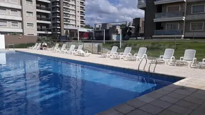 a swimming pool with lounge chairs and a swimming pool at Hotel Cardiólogico in Cordoba