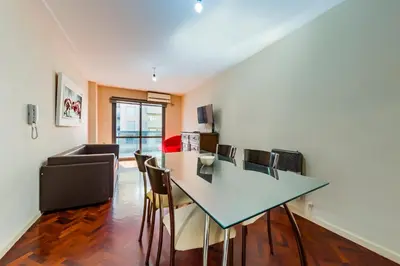 a living room with a dining room table and chairs at Viaggiato Larrañaga II in Cordoba