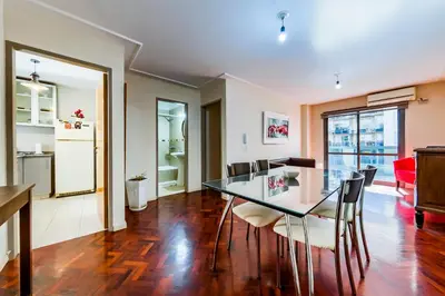 a dining room with a glass table and chairs at Viaggiato Larrañaga II in Cordoba